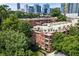 Attractive brick building nestled among mature trees, exuding curb appeal and timeless charm at 273 12Th Ne St # 111, Atlanta, GA 30309
