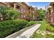 A row of brick townhouses with lush green landscaping and walkways, showcasing the neighborhood's appeal at 273 12Th Ne St # 111, Atlanta, GA 30309