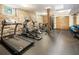 Home gym equipped with a treadmill, elliptical, weights and exposed stone wall at 273 12Th Ne St # 111, Atlanta, GA 30309