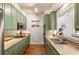 Galley kitchen featuring sage cabinetry, granite countertops, stainless appliances, and a view to the living room at 273 12Th Ne St # 111, Atlanta, GA 30309