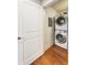 A tidy laundry room with a stacked washer and dryer set, conveniently located behind a white paneled door at 273 12Th Ne St # 111, Atlanta, GA 30309