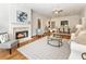 Bright living room featuring a cozy fireplace, hardwood floors, and a neutral color palette with ample seating options at 273 12Th Ne St # 111, Atlanta, GA 30309