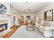 Open-concept living room with hardwood floors, fireplace, and a dining area that offers comfortable seating and a bright atmosphere at 273 12Th Ne St # 111, Atlanta, GA 30309