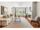 Open-concept living room featuring hardwood floors, comfortable seating, a fireplace and large windows for natural light at 273 12Th Ne St # 111, Atlanta, GA 30309