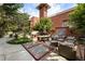 Charming outdoor patio with stone floors, brick accents, a grill, and ample seating for entertaining guests at 273 12Th Ne St # 111, Atlanta, GA 30309