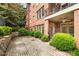 Private patio with brick accents, offering a tranquil outdoor space surrounded by lush greenery at 273 12Th Ne St # 111, Atlanta, GA 30309