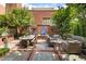 Outdoor patio area offers a stone floor, brick accents, a grill, and plenty of seating at 273 12Th Ne St # 111, Atlanta, GA 30309