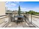 Rooftop deck with wrought iron table and chairs, offering beautiful city views at 273 12Th Ne St # 111, Atlanta, GA 30309