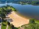 Picturesque lakefront with a sandy beach and clear blue water with swimming area, perfect for relaxation and recreation at 4442 Academy St, Acworth, GA 30101