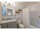 Bright bathroom featuring shiplap walls, a modern vanity, and a shower/tub combo at 4442 Academy St, Acworth, GA 30101