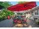 Outdoor deck with red patio umbrella, dining table, and a cozy setup ideal for outdoor gatherings at 4442 Academy St, Acworth, GA 30101