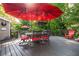 Outdoor deck with a red umbrella, stylish seating, and a cozy bar area perfect for relaxing at 4442 Academy St, Acworth, GA 30101