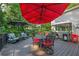 Outdoor deck with a red umbrella, dining set, and seating area great for outdoor dining and relaxation at 4442 Academy St, Acworth, GA 30101