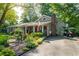 Charming single-Gathering home featuring a brick chimney, landscaped front yard, and ample parking on a sunny day at 4442 Academy St, Acworth, GA 30101