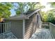 Exterior view of home with wood siding and access to a deck overlooking trees at 4442 Academy St, Acworth, GA 30101