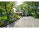 Charming home featuring a well-manicured front yard, mature trees, and a long driveway at 4442 Academy St, Acworth, GA 30101