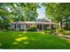 Inviting single-story house showcasing a large green lawn, well-maintained landscaping, and traditional architectural details at 4442 Academy St, Acworth, GA 30101
