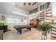 Open game room with a pool table, spiral staircase, and views into the kitchen and dining areas at 4442 Academy St, Acworth, GA 30101