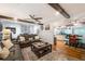 Open-concept living room flows to kitchen and dining areas, featuring hardwood floors, comfortable seating, and stylish decor at 4442 Academy St, Acworth, GA 30101