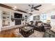 Cozy living room features wood beams, a brick fireplace, built-in shelves, hardwood floors, and comfortable seating at 4442 Academy St, Acworth, GA 30101