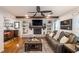 Inviting living room showcasing a brick fireplace, built-in shelves, hardwood floors, and comfortable seating near dining area at 4442 Academy St, Acworth, GA 30101