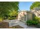 Practical shed with a door and concrete area, surrounded by greenery and a fenced yard at 4442 Academy St, Acworth, GA 30101