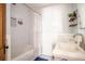 Bathroom featuring classic white tile, vanity, and shower with tub, and an upscale faucet fixture at 2411 Fair Lane Ln, Decatur, GA 30032