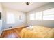 Bright bedroom with three windows, wood floors, and a cozy yellow comforter at 2411 Fair Lane Ln, Decatur, GA 30032