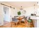 Bright dining room featuring a modern light fixture, table for six and a sliding barn door at 2411 Fair Lane Ln, Decatur, GA 30032