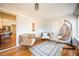 Bright sunroom with wicker furniture, hanging egg chair, and hardwood floors at 2411 Fair Lane Ln, Decatur, GA 30032