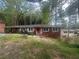 Cozy brick home featuring a red front door, large windows, and covered front porch at 481 Hammond Dr, Atlanta, GA 30328