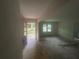 Open-concept space with views to the entrance, window with natural light, and unfinished floor at 481 Hammond Dr, Atlanta, GA 30328