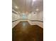 Basement featuring a painted floor, white walls with dark trim, and ceiling fan lights at 713 Trickum Valley Dr, Woodstock, GA 30188
