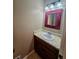 Powder room featuring tiled floors, a wood vanity, and a framed mirror at 713 Trickum Valley Dr, Woodstock, GA 30188