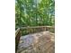 Large wooden deck offering serene views of the surrounding lush greenery at 713 Trickum Valley Dr, Woodstock, GA 30188