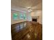 Bright living room boasting hardwood floors, fireplace and multiple windows to outdoors at 713 Trickum Valley Dr, Woodstock, GA 30188