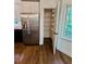 Bright kitchen featuring stainless steel refrigerator and a well-organized, shelved pantry at 713 Trickum Valley Dr, Woodstock, GA 30188