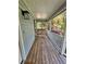 Charming covered front porch featuring a classic swing and wood flooring at 713 Trickum Valley Dr, Woodstock, GA 30188
