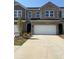 Charming townhome featuring a two-car garage and traditional brick facade at 942 Elwood St, Dacula, GA 30019