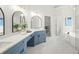 Elegant bathroom boasts double sinks, quartz countertops, soaking tub and walk in shower at 135 Emerald Ln, Roswell, GA 30075