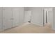Bright bedroom featuring neutral walls, carpet, and a double door closet for ample storage space at 135 Emerald Ln, Roswell, GA 30075