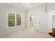 Bright bedroom featuring a large window and a closet with neutral walls and carpet flooring at 135 Emerald Ln, Roswell, GA 30075