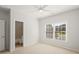 Well-lit bedroom features neutral walls, ceiling fan, a window, and an en-suite bathroom, creating a comfortable retreat at 135 Emerald Ln, Roswell, GA 30075