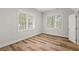 Bright bedroom with two windows providing natural light and wood-look floors at 135 Emerald Ln, Roswell, GA 30075