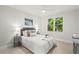 Comfortable bedroom featuring a ceiling fan, large window and neutral tones at 135 Emerald Ln, Roswell, GA 30075