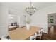 Elegant dining room with hardwood floors, designer lighting, and wainscoting at 135 Emerald Ln, Roswell, GA 30075