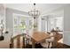Formal dining room with detailed trim, chandelier, wood floors, and lots of natural light at 135 Emerald Ln, Roswell, GA 30075