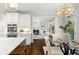 Bright kitchen featuring white cabinetry, stainless steel appliances, and an adjacent breakfast nook with a stylish chandelier at 135 Emerald Ln, Roswell, GA 30075