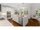Modern kitchen boasting a center island with marble countertops, stainless steel appliances, and hardwood floors at 135 Emerald Ln, Roswell, GA 30075