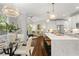 Open-concept kitchen with a center island, stainless steel appliances, hardwood floors, and a view of the living area at 135 Emerald Ln, Roswell, GA 30075